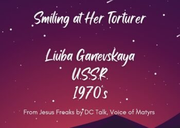 SMILING AT HER TORTURER